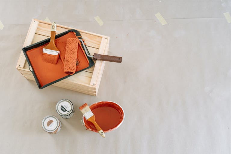 Explore this overhead view of essential painting tools and supplies perfect for home renovation projects.